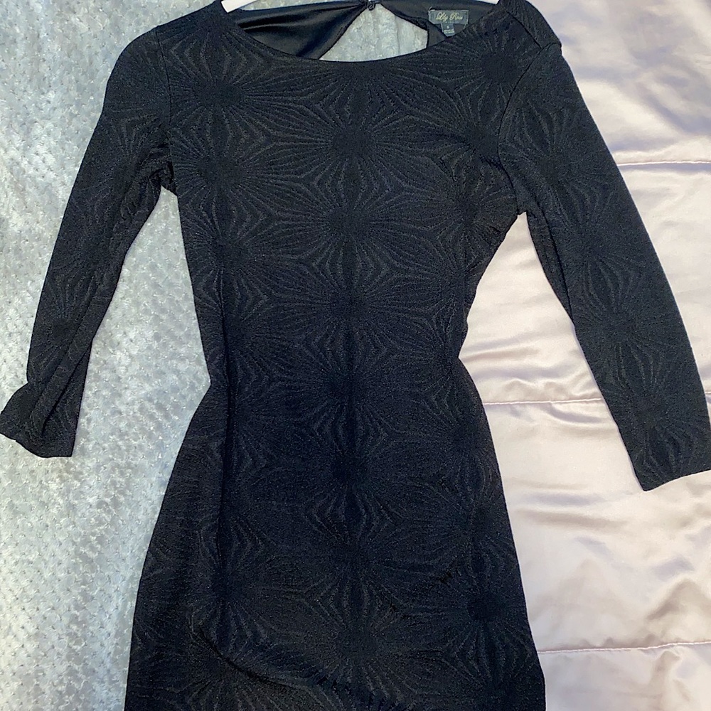black tight fitting dress with open back.